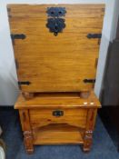 A pine two tier occasional table with a fitted drawer together with a storage box with metal mounts.