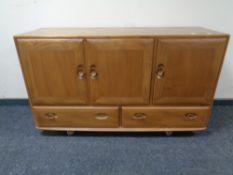 An Ercol elm and beech three door,