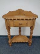 A pine two-tier corner table fitted a drawer