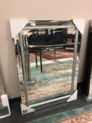 A contemporary bevelled mirror,