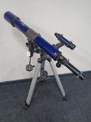 A Skylux telescope on tripod.