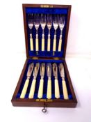 An Edwardian oak canteen of fish cutlery