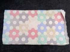 A hand-stitched patchwork quilt.