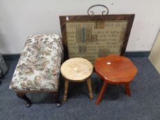 A contemporary tapestry fire screen together with and adjustable stool and two milking stools.