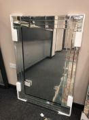 An all glass contemporary mirror, 83cm x 121cm.