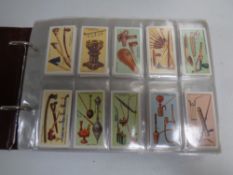 A cigarette card album containing Ogdens, Wills, Churchman,