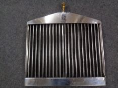 A Rolls-Royce chrome grill with gilt Spirit of Ecstasy mascot.