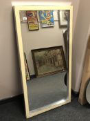 A contemporary mirror in a cream frame 69cm x 130cm.