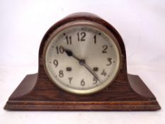 An oak cased 8 day mantel clock with silver dial.