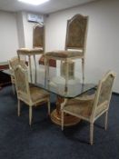 A contemporary Italian style glass-topped dining table on two cylindrical gilt pedestals together