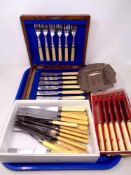 A tray containing an embossed silver dish converted from a card case,