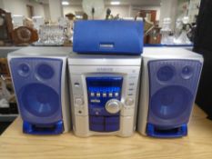 A Kenwood RXD-853 CD cassette HiFi with three speakers.