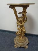 A gilt composite cherub plant stand.