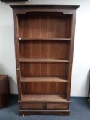 A set of open bookshelves fitted with two drawers beneath