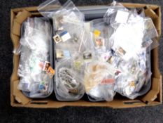 A box containing a large quantity of world stamps.