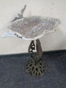 A cast metal bird bath.