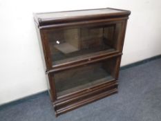 An Edwardian Globe Wernicke two-tier oak stacking bookcase on stand