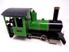 A hand built model steam engine 'Iver' with a Futaba remote handset and box containing track.