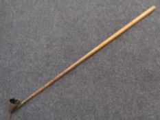An antique ecclesiastical candle snuffer (length 111cm).