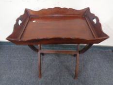 A mahogany butlers tray on stand.