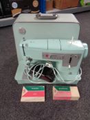 A Singer electric sewing machine in case.