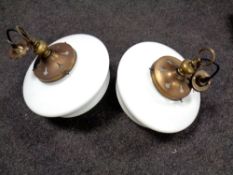 A pair of 20th century opaque glass pendant light fittings with shades.