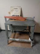 An electric table saw with extra blades.