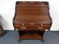 An Edwardian mahogany roll top desk with key.