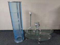 A contemporary metal and glass oval coffee table together with similar bathroom stand and bathroom