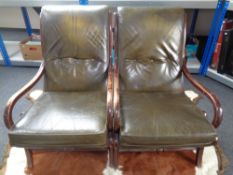 A pair of mid 20th century beech framed Parker Knoll armchairs upholstered in green button leather.