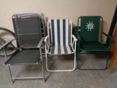 Seven assorted folding garden chairs.