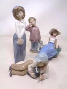 Four Nao figures including girl with puppy.