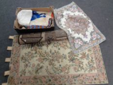 A fringed woolen rug together with a chain stitch rug and wall hanging