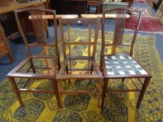 A pair of pine wall shelves together with three inlaid mahogany bedroom chairs.