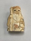 A carved bone Chinese netsuke - village elder with staff