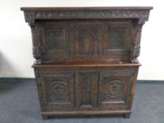 A heavily carved 19th century oak buffet back sideboard.