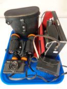 A set of Neptune 7x50 field glasses in case together with two vintage cameras and a Cinecamera.