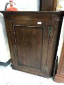 A George III oak hanging corner cabinet.
