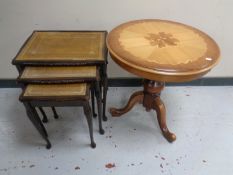 An Italian style pedestal wine table together with a further nest of three glass and leather topped