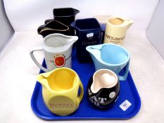 A tray of china jugs baring brewery advertising including Tennants, Whyte & Mackay, Dewar's etc.