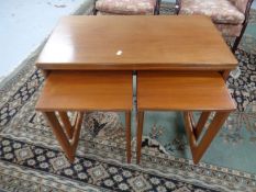 A 20th century teak G Plan turnover top tea trolley fitted with two tables beneath.
