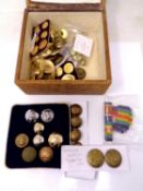 A tooled leather box containing military buttons.