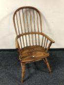 A 19th century elm stick back Windsor kitchen armchair.