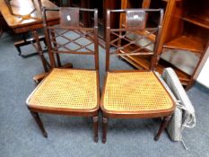 A pair of 19th century inlaid mahogany bergere seated bedroom chairs.