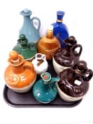 A tray of mainly empty whiskey decanters including Ballantine's scotch whiskey,