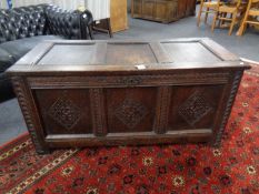 A George III panelled oak coffer with carved initials 'WH', with key (width 122cm).