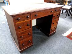 A Victorian mahogany twin pedestal desk fitted with nine drawers and a leather inset panel.