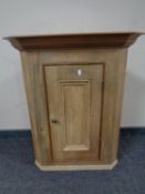 A pine hanging corner cabinet.