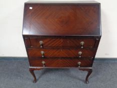 A 20th century mahogany bureau on Queen Anne legs.
