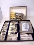 A box and a case containing assorted stainless steel and plated cutlery together with a further